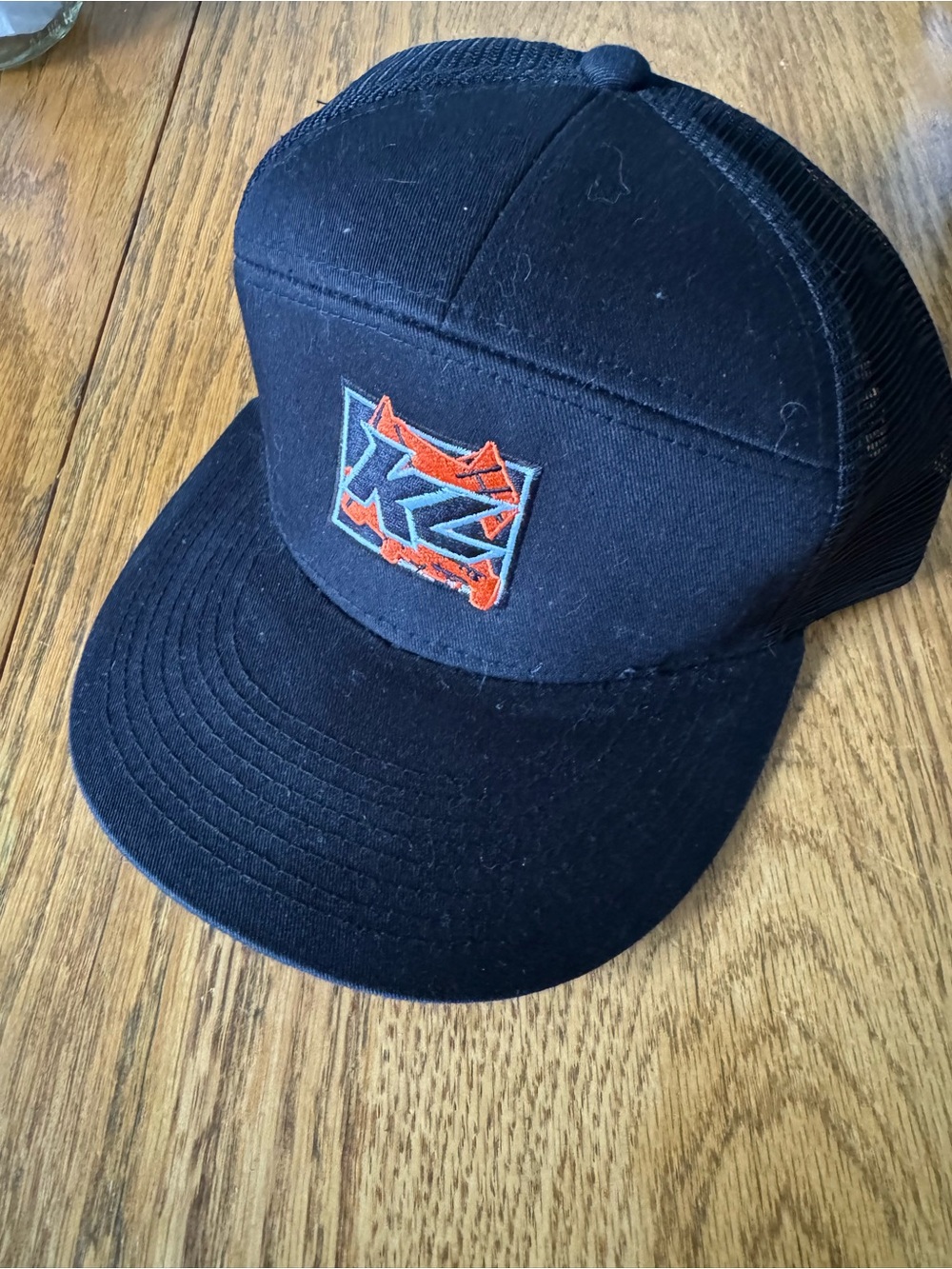 Kyle Larson Black Trucker Hat with Orange & Blue Logo